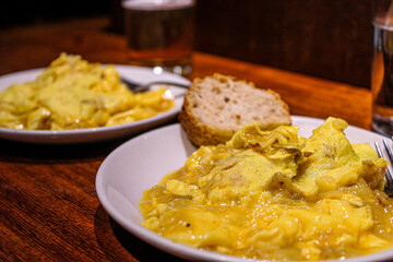 Potato and egg scrambled as a pintxo in a bar of the old town in San Sebastian. Basque Cuisine in a vegetarian pintxo. 