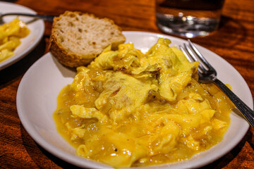 Potato and egg scrambled as a pintxo in a bar of the old town in San Sebastian. Basque Cuisine in a vegetarian pintxo. 