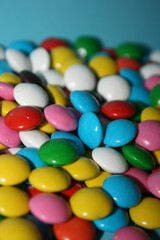 multicolored delicious candies with chocolate on a blue background
