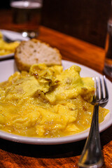 Potato and egg scrambled as a pintxo in a bar of the old town in San Sebastian. Basque Cuisine in a vegetarian pintxo. 