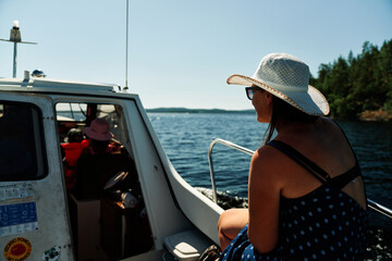 Family boat trip on Päijänne, Finland on a hot summer day. 