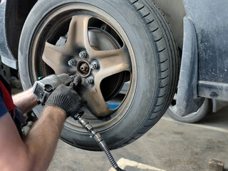 Close-up of the wheel replacement. Maintenance and repair of passenger cars in the service center.