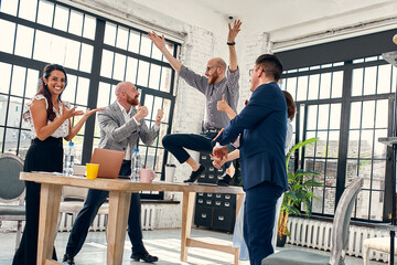 Excited diverse business team employees screaming celebrating good news business win corporate...