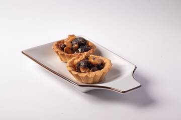 Cookies, nuts and raisins on a white background