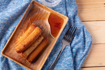 Fish ball fried with dipping sauce on a blue napkin