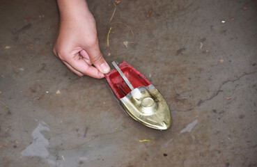 A kid sailing or launching her toy motor boat in water