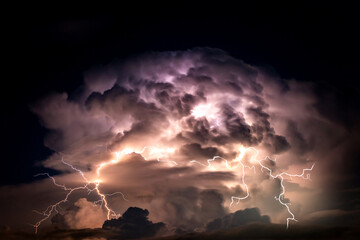 Dark cloud at  night with thunder bolt. Heavy storm bringing thunder, lightnings and rain in summer.