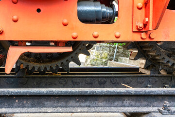 Naklejka premium Close-up of cogwheel railway line. Close-up of railways cog mechanism