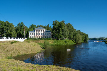Fototapeta na wymiar View of the Uglich Museum with white columns and the Stone Stream.
