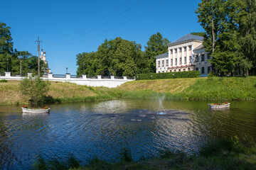 Fototapeta na wymiar A fountain and two white boats with flowers in Kamenny Brook in Uglich, Yaroslavl Region.