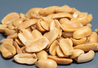 Roasted salted peanuts placed on a gray background