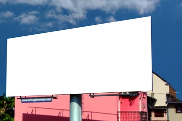 Fototapeten Large billboard ad panel in urban residential setting with blue sky and white clouds background. blank white image template for mockup. horizontal ad template © Istvan