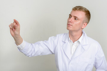 Portrait of young man doctor with blond hair