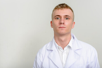 Portrait of young man doctor with blond hair