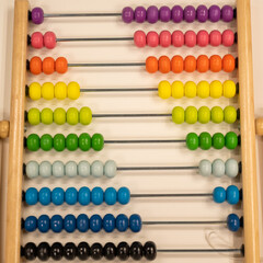 Bright colored hand abacus. Children's wooden toy for the study of arithmetic.