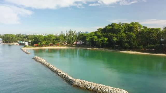 Aerial shot of tropical kusu island with city skyline, Singapore