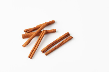 Cinnamon sticks on white background, place for text