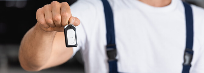 panoramic orientation of mechanic holding car key