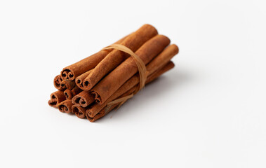 Cinnamon sticks on white background, place for text