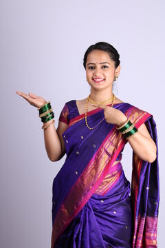 Beautiful Indian girl wearing sari showing hand gestures.