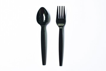 black  plastic spoon and fork for single used on white background