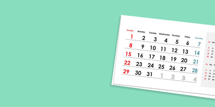 Top view of calendar board. The card is arranged at an angle. Shadow falling on mint green pastel background. Copy free space for your artwork. Planning for business meeting or travel.