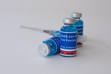Vaccine bottles and syringe for the prevention of new Coronavirus infection COVID-19 or SARS-CoV-2 on a white background.