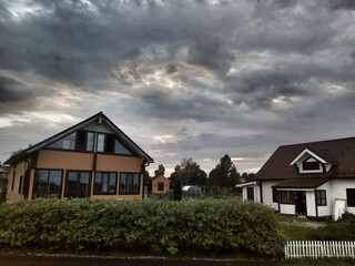 houses on the hill on a dark clouds