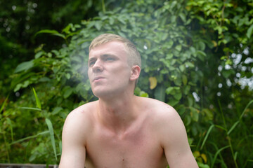 Portrait of young man with blond hair shirtless outdoors