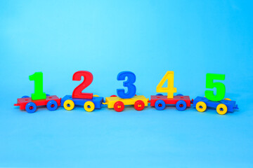 Сolorful numbers 1,2,3,4,5.  numbers  train. Bright colors of red yellow green blue on a blue background. Early childhood education, learning to count, preschool and kids game concept. School concept.