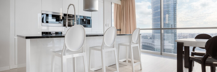 White kitchen with big windows, panorama