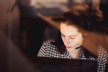 Fototapeta premium The programmer girl works at the computer