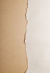 Wrapping gray paper with torn edges.Torn white and brown paper background.Craft paper background, top view and close up.
