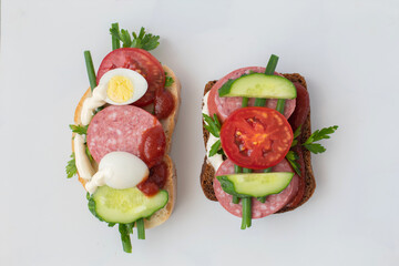Two sandwiches are on the table. The sandwiches are delicious, tasty, but not healthy.