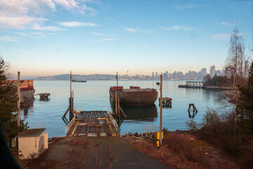 Rusty barge foreground with Seattle skyline background blue sky day