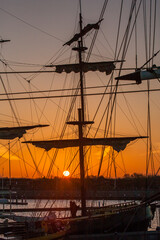 A tall ship sail boat with sails rolled,  moored in a port at Hoorn, Netherlands