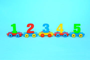 Сolorful numbers 1,2,3,4,5.  numbers  train. Bright colors of red yellow green blue on a blue background. Early childhood education, learning to count, preschool and kids game concept. School concept.