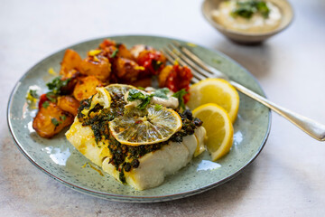 Cod fillets with coriander crust, lemon and bay leaf and spicy rost potatoes