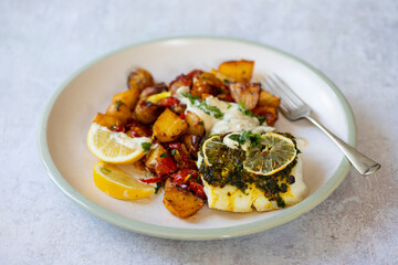 Cod fillets with coriander crust, lemon and bay leaf and spicy rost potatoes
