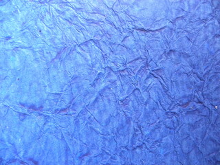 Blue color rustic crumpled paper textured background