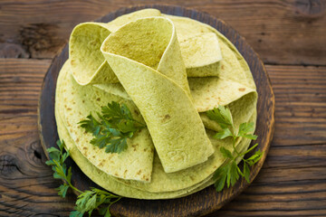 Green spinach tortilla on the wooden table