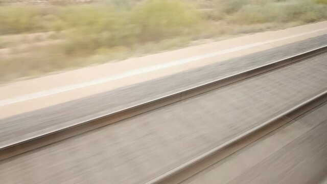 View of the train tracks seen from above moving at speed and blurred