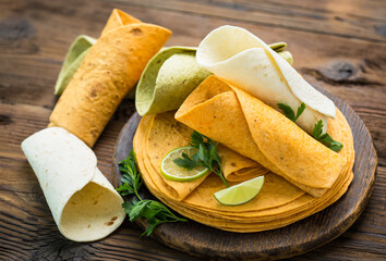 Different kinds of tortillas on the wooden table