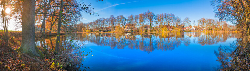 Beautiful fall scenery panorama on the lake on a sunny day