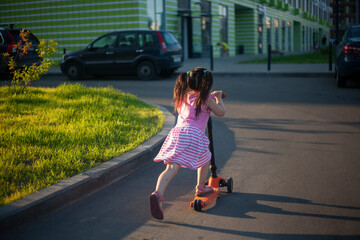 A child on a scooter.