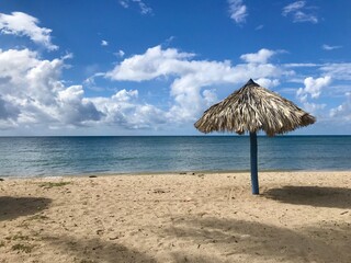 Peaceful and relaxing travel destination in Cuba (Caribbean): Dreamlike Playa Ancon with white sand, turquoise ocean and blue sky is an idyllic vacation paradise