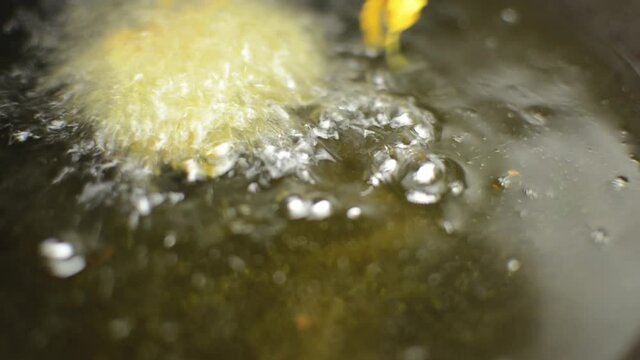 Close up shot of frying pakoras in hot oil, Mumbai's street food in India.