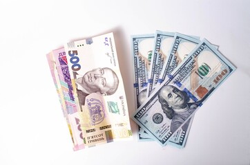 Banknotes Ukrainian hryvnia and dollars on a white background in close-up.