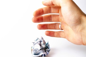 Crumpled, burnt dollar bills on a white background in close-up and in a man's hand