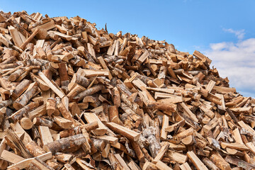 huge pile of firewood against the sky